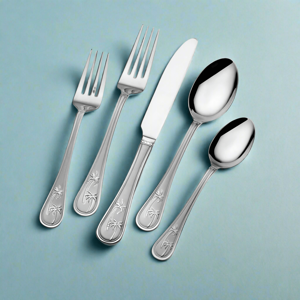 Palm Breeze flatware set displayed on a beautifully set table showcasing its tropical design.