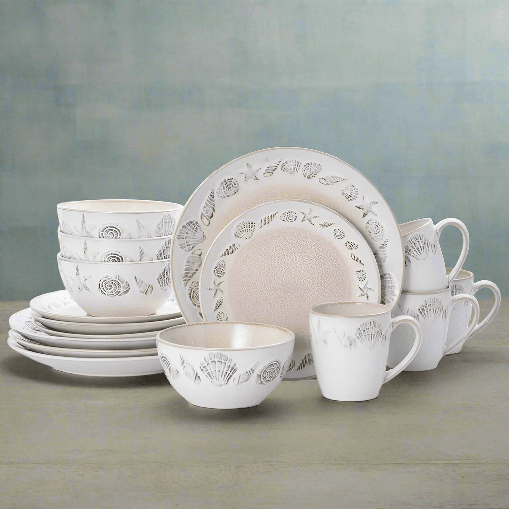 Top-down view of reactive glaze dinnerware set with mugs arranged on a wooden dining table