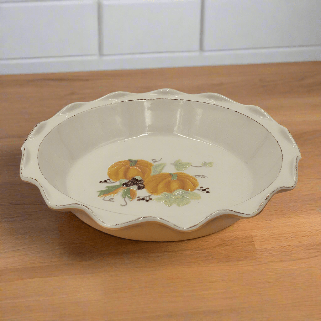 Close-up of pumpkin design on scalloped rim pie plate for fall baking