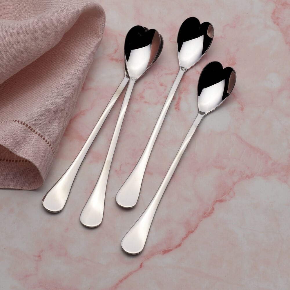 Heart-shaped iced beverage spoon set displayed on a rustic table.