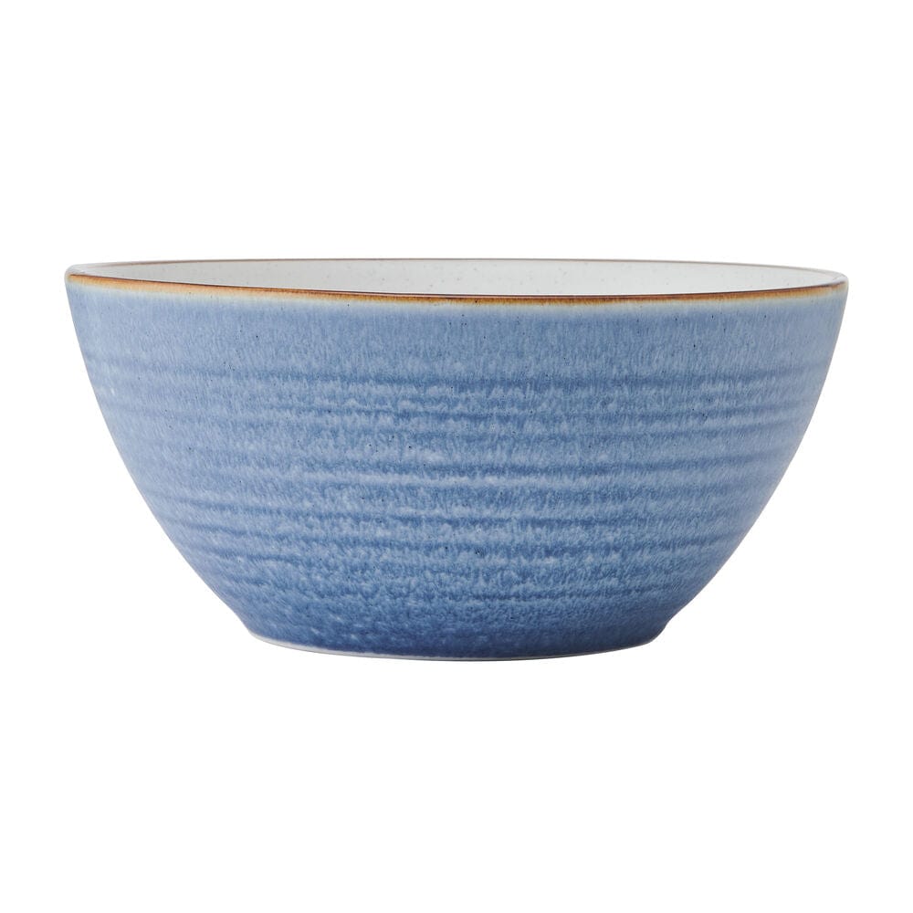 Rowan Blue dinner plates featuring concentric circles and a warm tan rim from an overhead angle