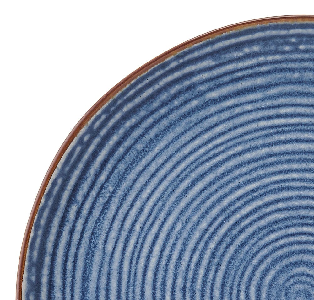 Set of blue stoneware dishes displayed on a dining table, perfect for everyday use