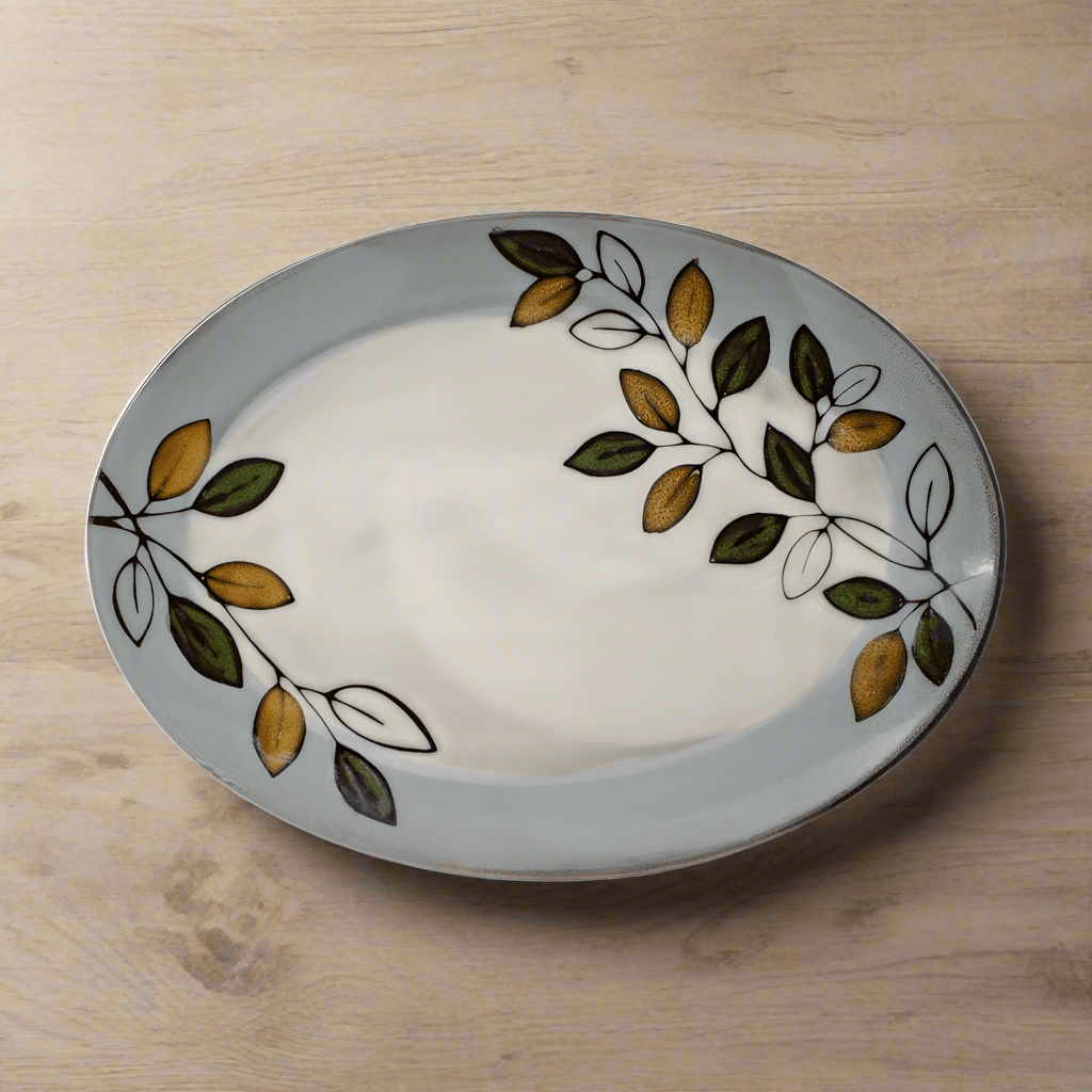 Close-up of rustic leaves design on oval stoneware serving platter