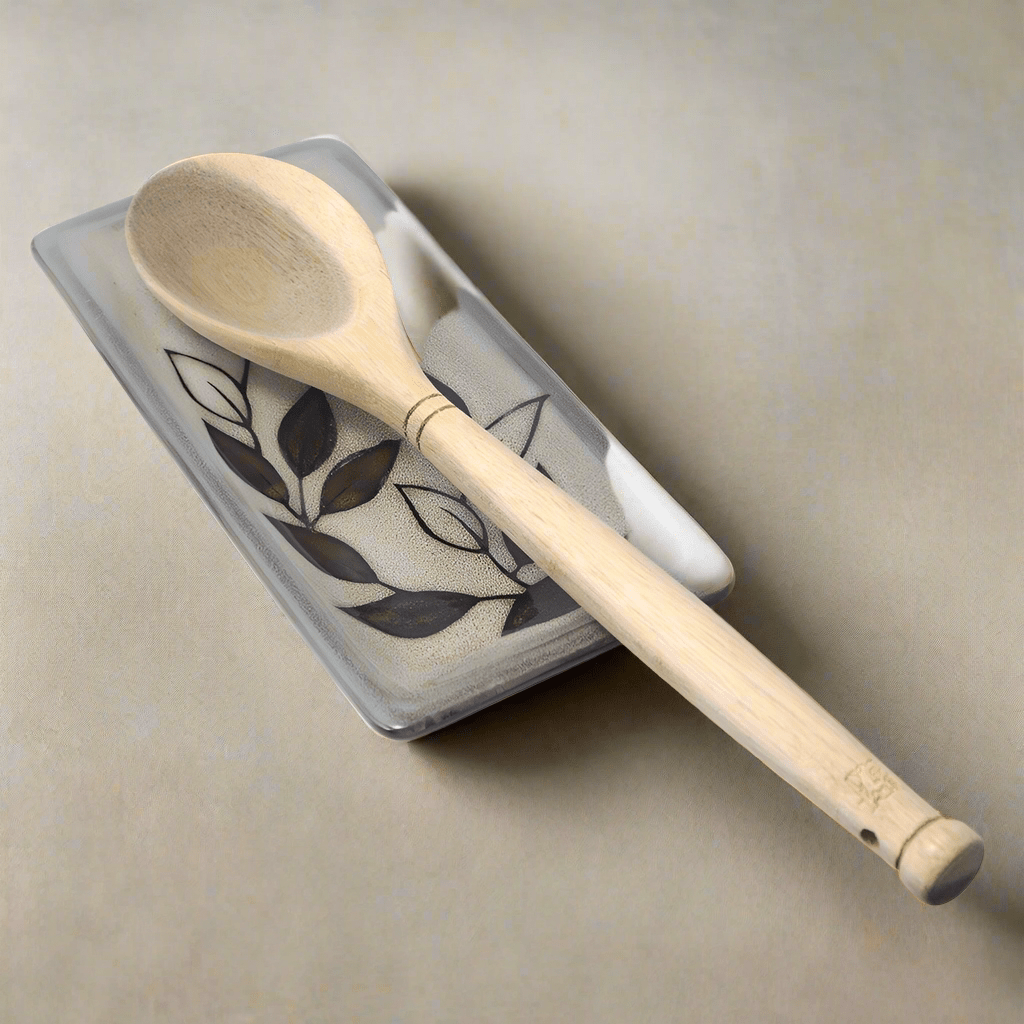 Close-up view of the rustic leaves stoneware spoon rest showcasing its unique reactive glaze.