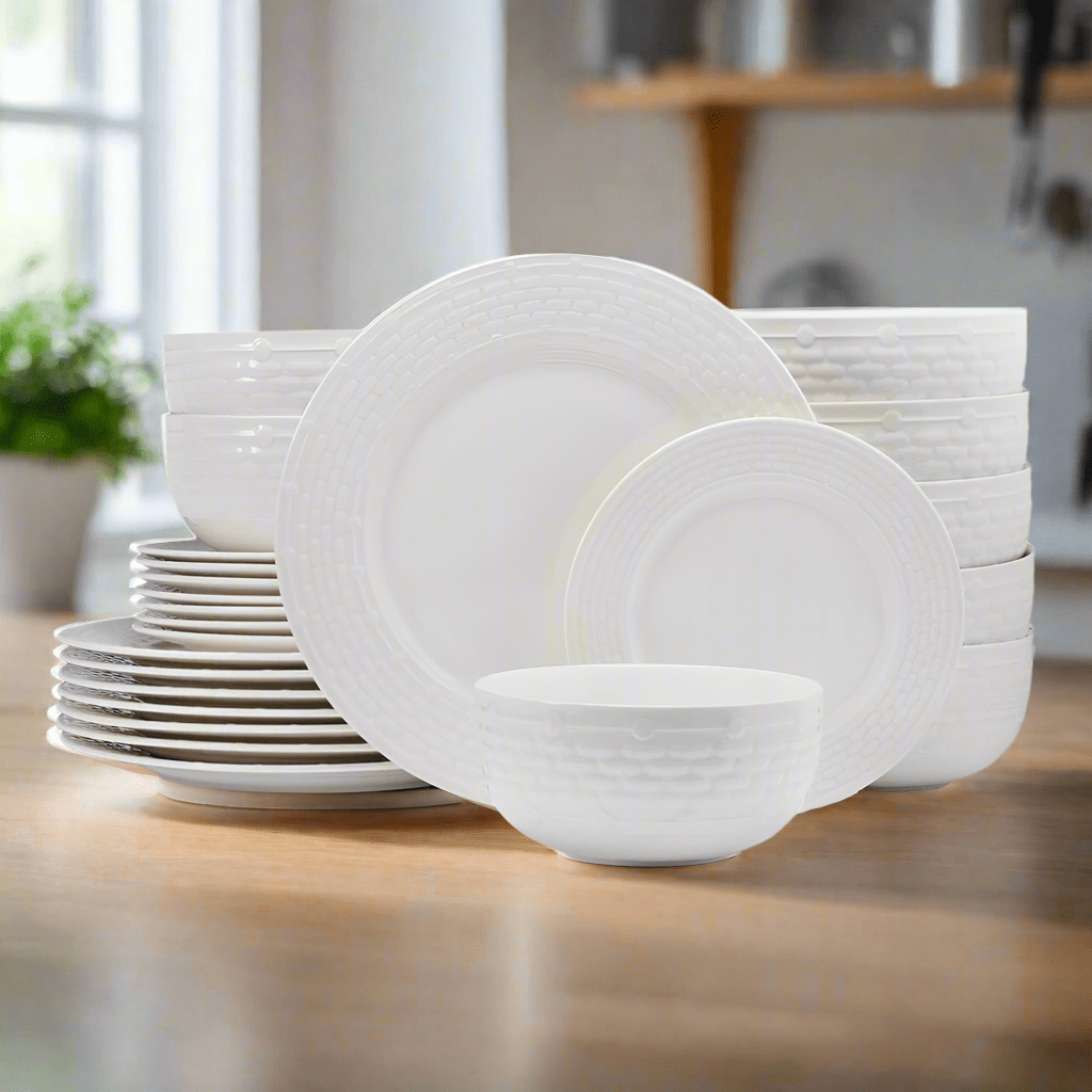 Overhead view of Sonya porcelain dinnerware set arranged for service for 8 on a rustic wood table