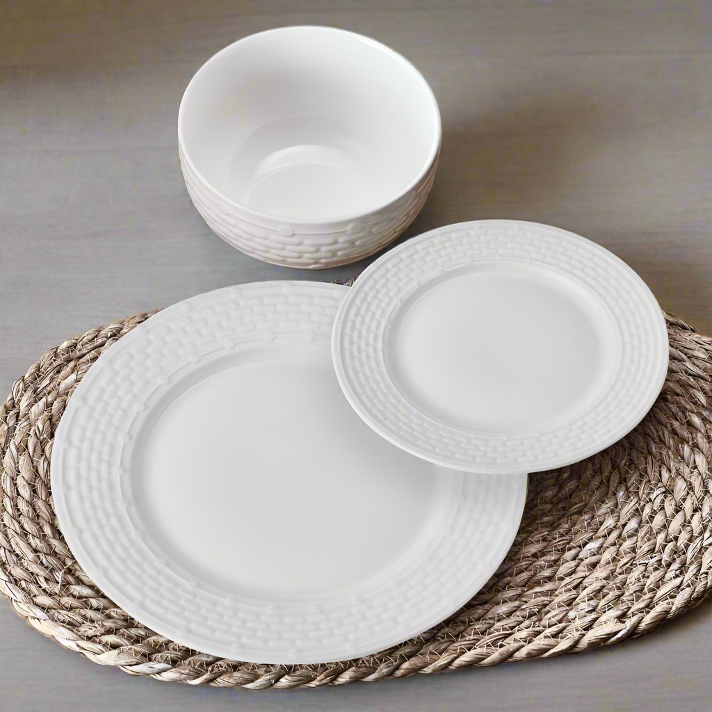 Close-up of embossed basket weave texture and beaded rim on white porcelain salad plate