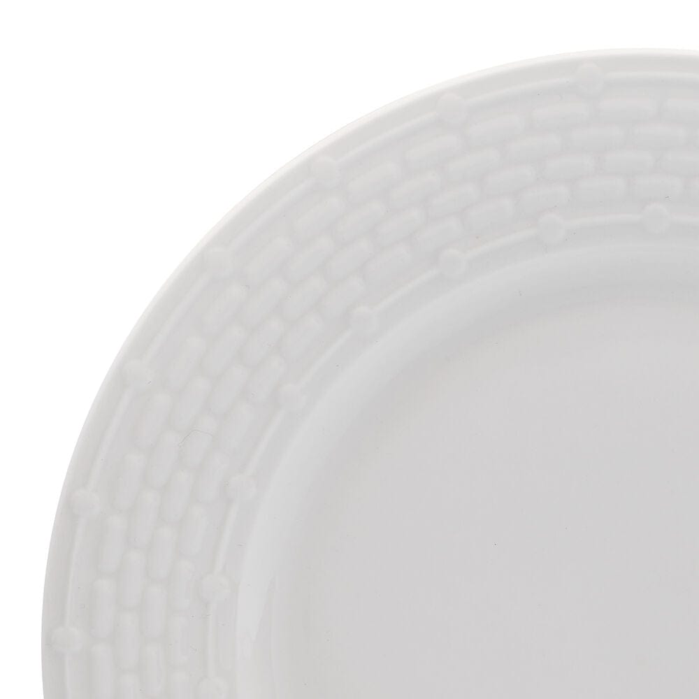 Overhead view of Sonya porcelain dinnerware set arranged for service for 8 on a rustic wood table
