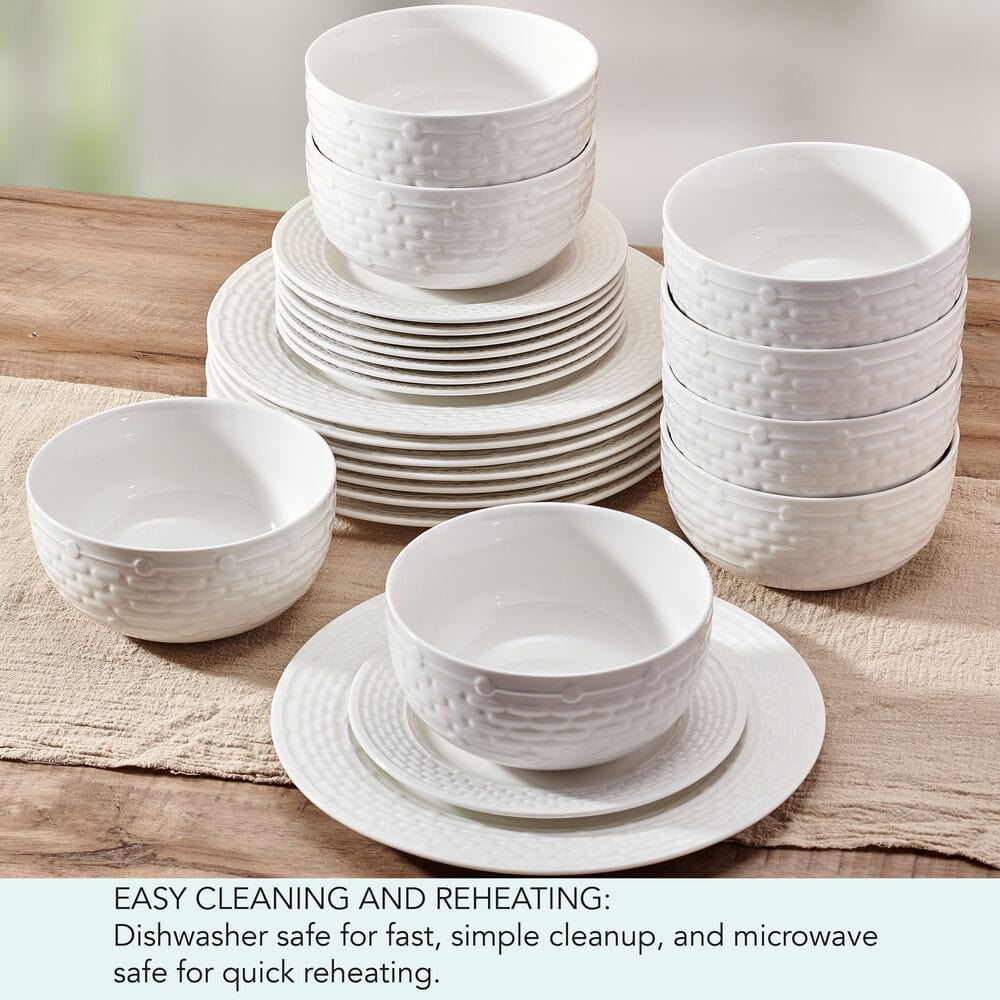 Overhead view of Sonya porcelain dinnerware set arranged for service for 8 on a rustic wood table
