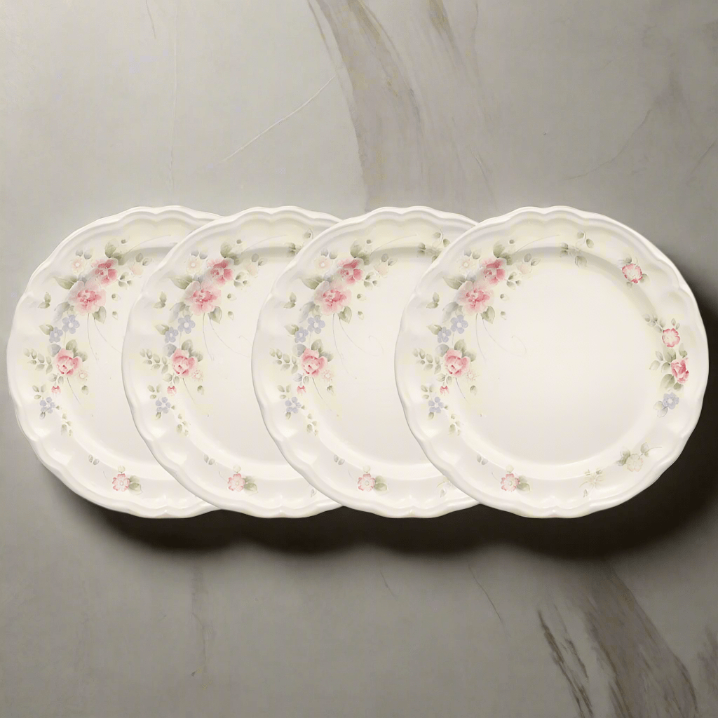 Close-up of a Tea Rose stoneware dinner plate showing the vintage floral design