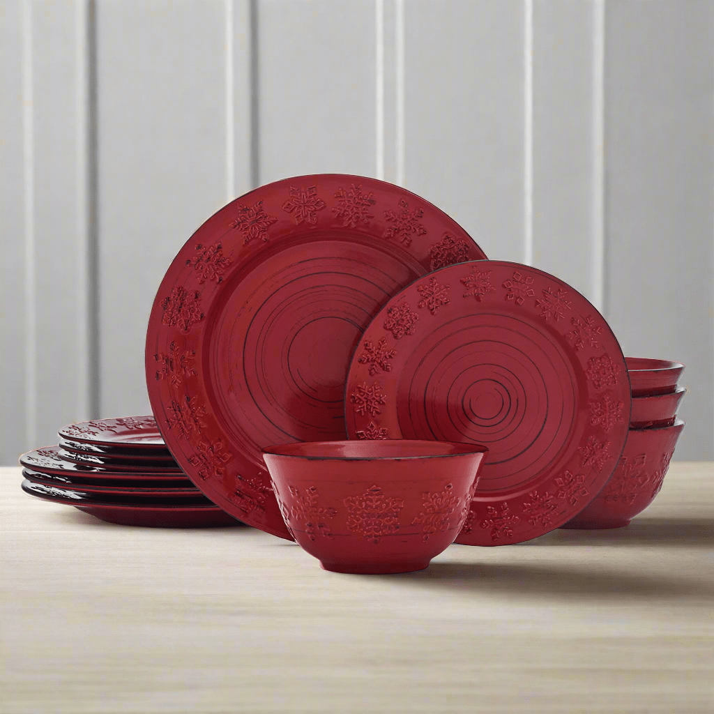Rustic Trellis Snowflakes Dinnerware Set featuring dinner plates, salad plates, and bowls with snowflakes design on a red background.