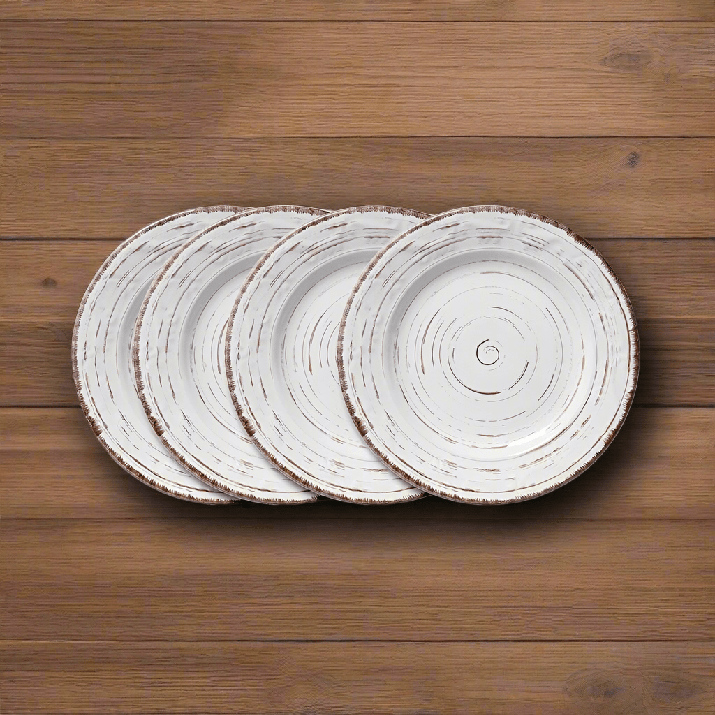 Elegant white stoneware salad plate on a dining table, ideal for serving salads.