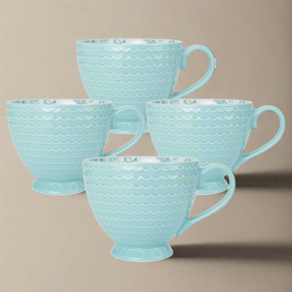 Close-up of coastal stoneware mug with seashell pattern for summer table setting