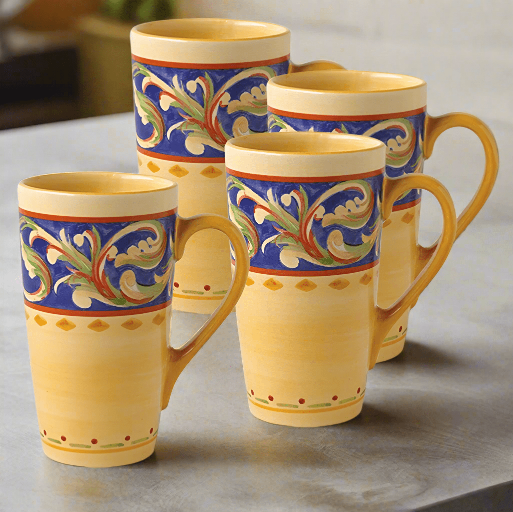 Overhead view of the set of 4 large coffee mugs with latte froth, placed on a rustic wooden table