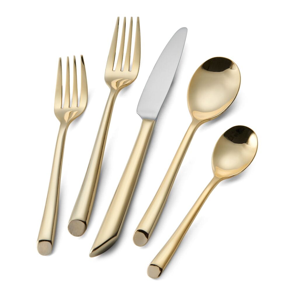 Close-up of the sleek, mirror-like handles of the Gold Wave flatware set.