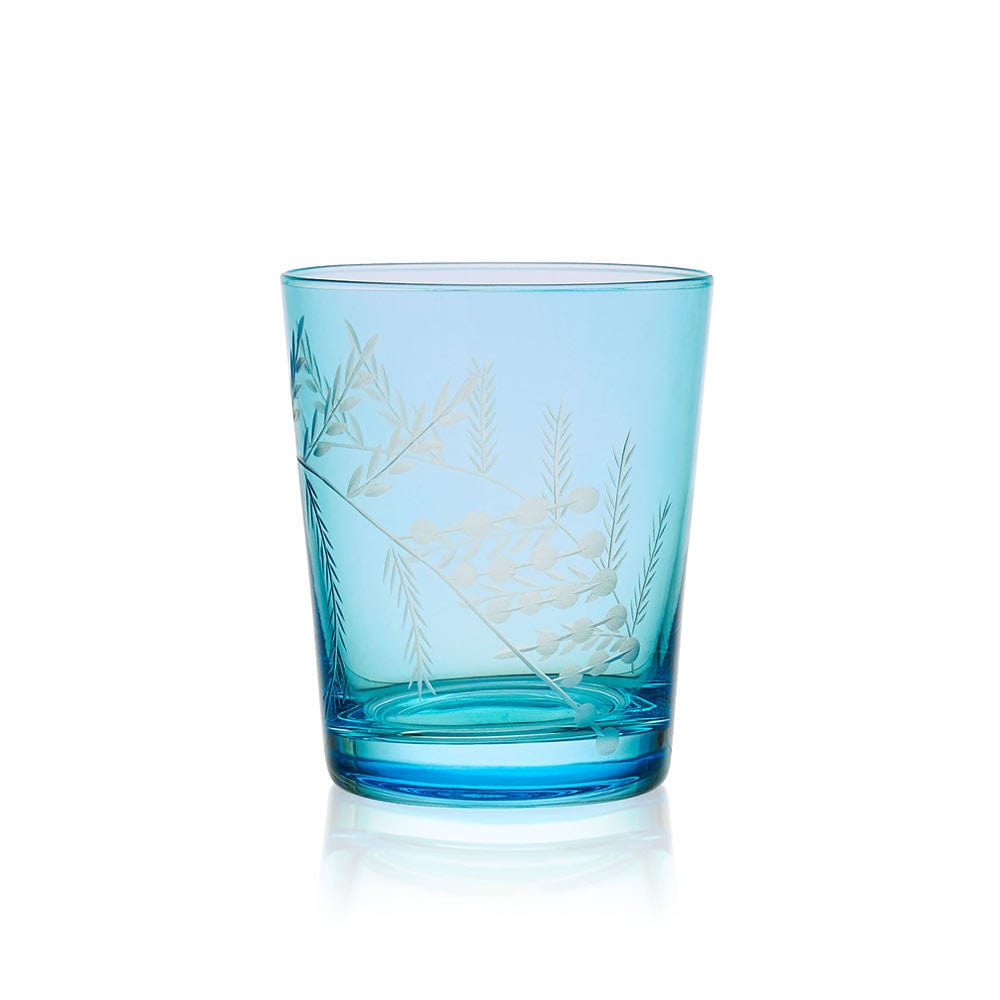Elegant blue whiskey glasses filled with cocktail, showcasing whimsical wildflower details