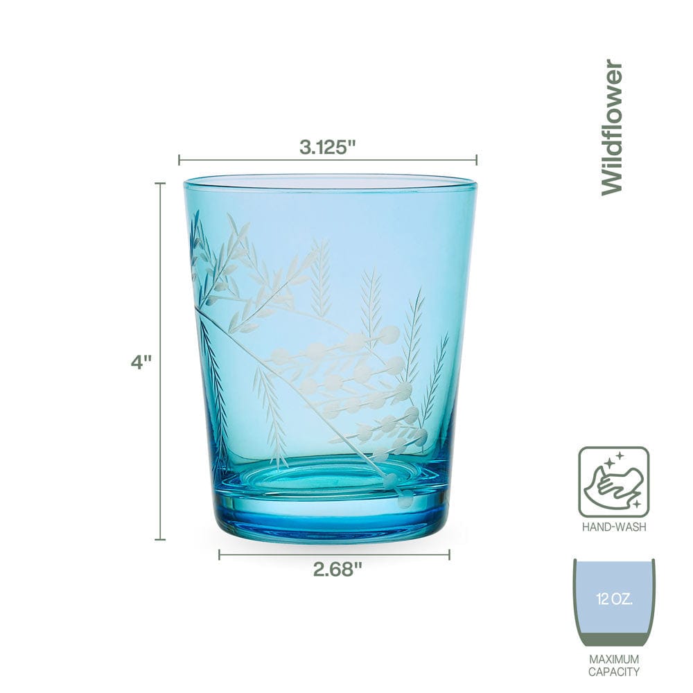 Close-up of hand-cut wildflower design on blue whiskey glass