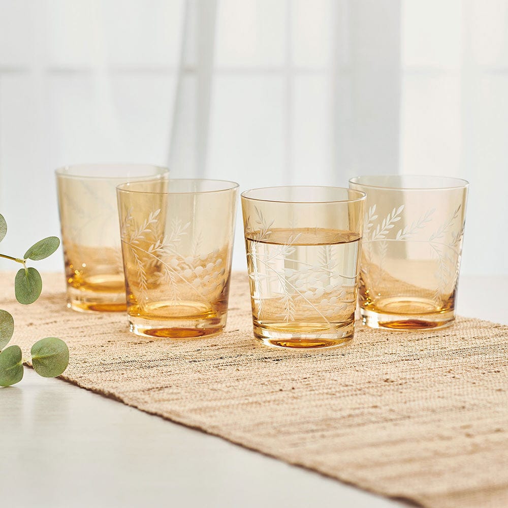 Fitz and Floyd double old fashioned glass set featuring hand-cut wildflower designs with gold accents, angled view.