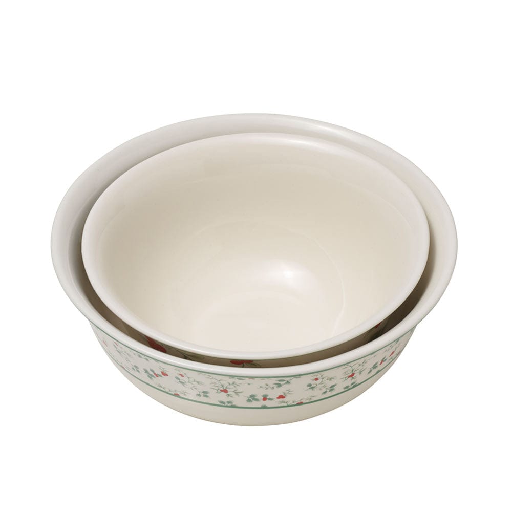 Large holiday serving bowl filled with seasonal treats on a table.