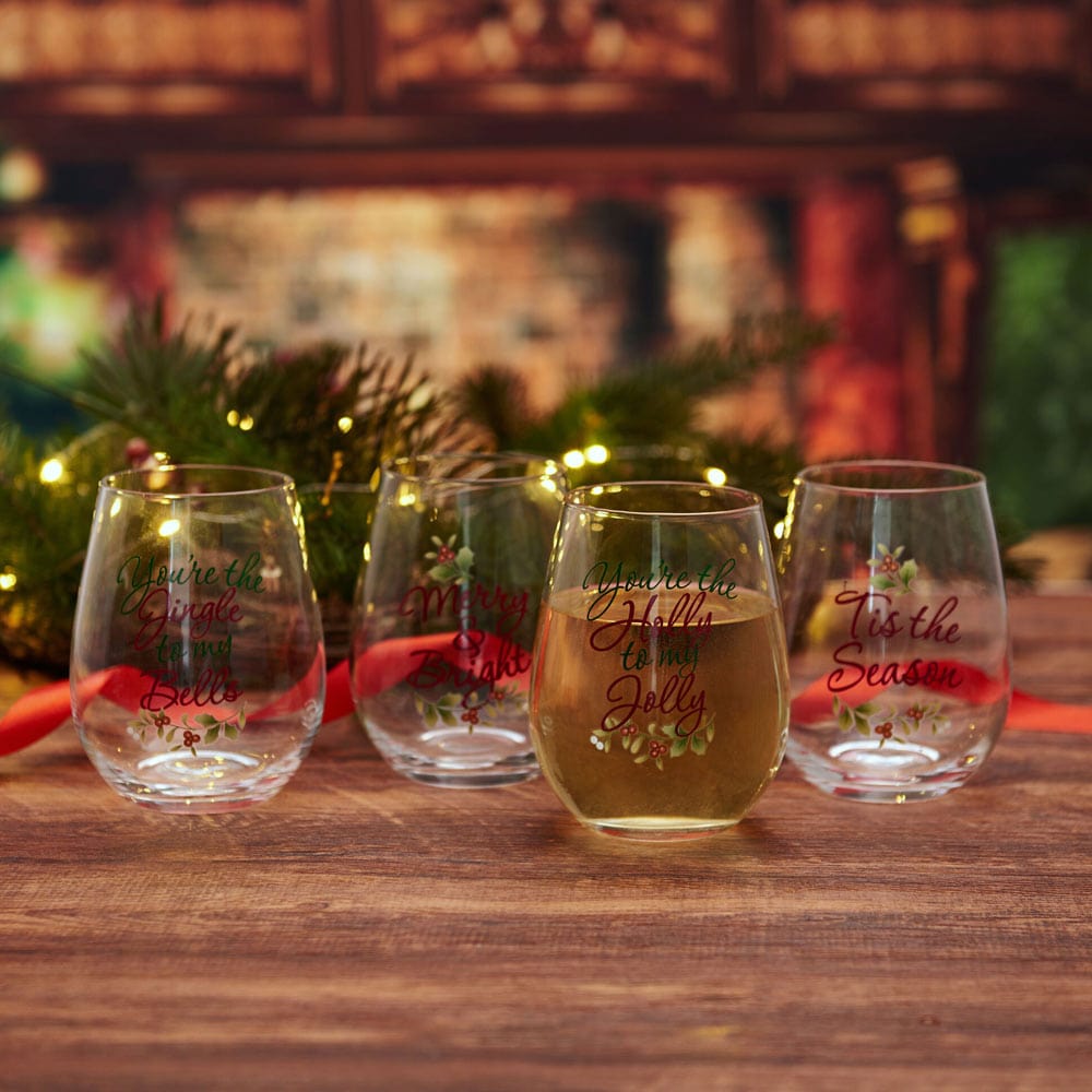 Set of four holiday wine glasses with Christmas sayings, ideal for gift-giving