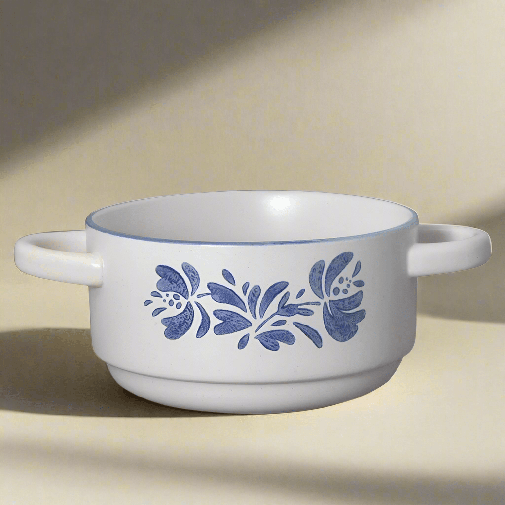 Top-down view of stoneware double handled soup bowl filled with tomato bisque