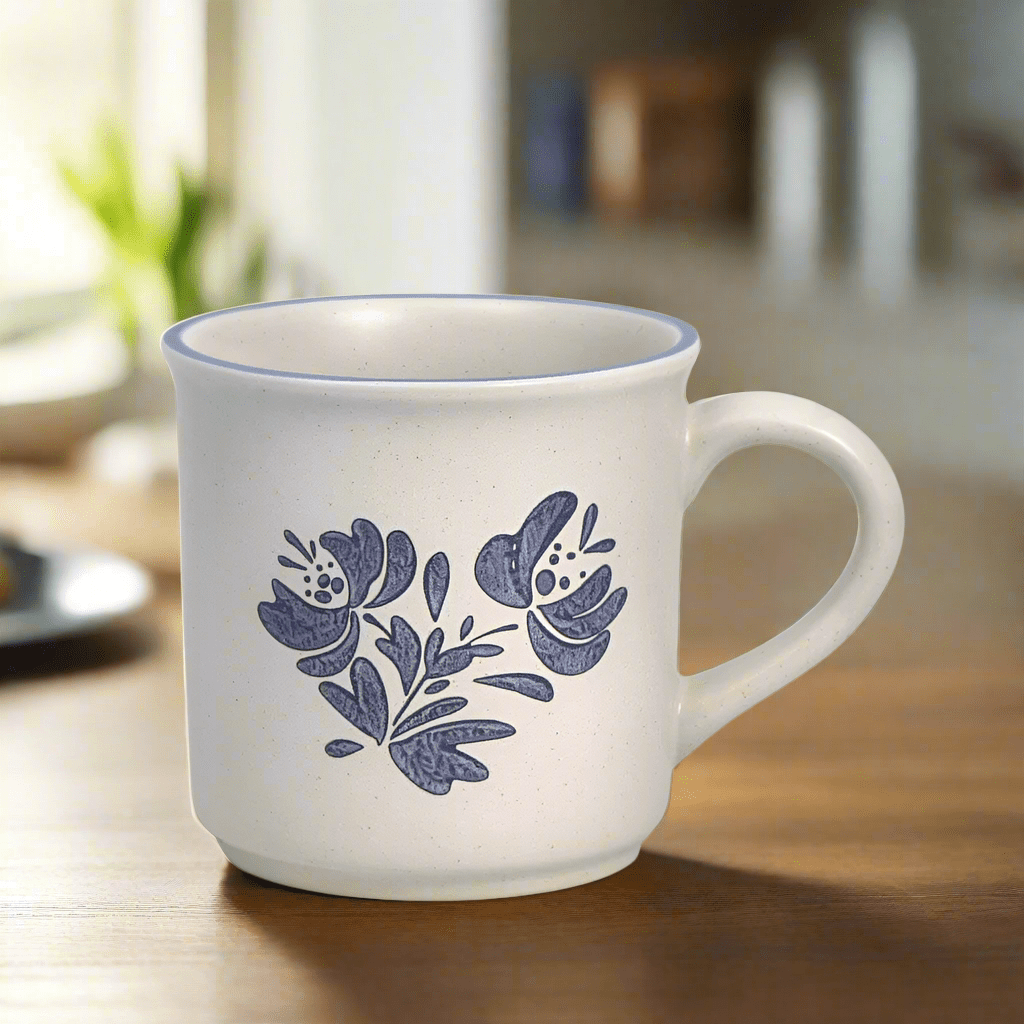 Angled view of the Yorktowne stoneware mug filled with coffee, showing its smooth glaze and sturdy handle