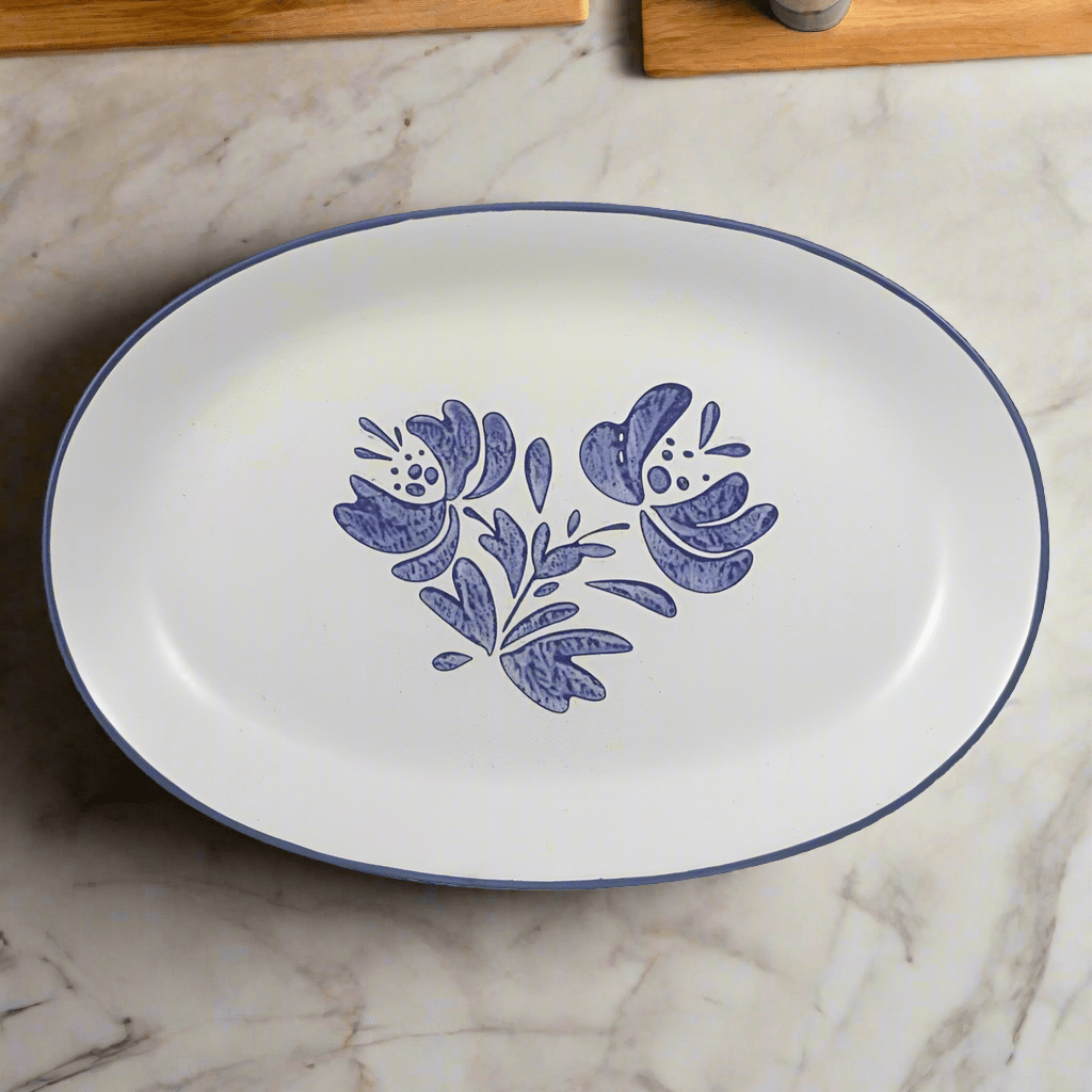 Close-up of large oval stoneware serving platter with grilled meats