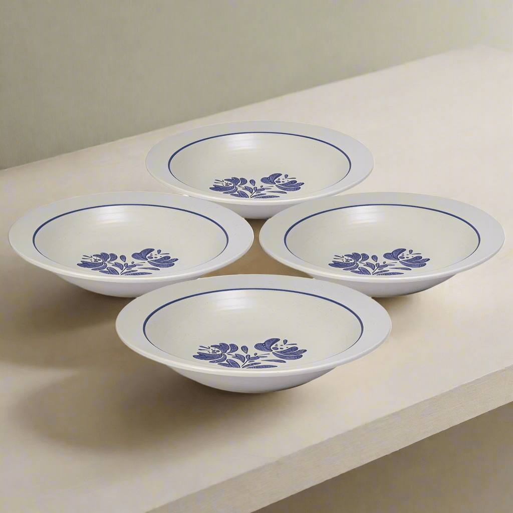 Yorktowne stoneware pasta bowl set displayed on a dining table, showcasing its elegant design.