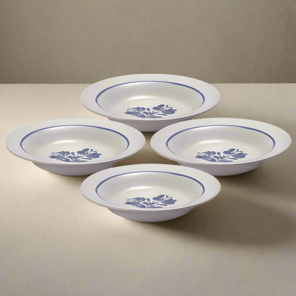Set of four stoneware rim soup bowls on a dining table, showcasing their stylish design