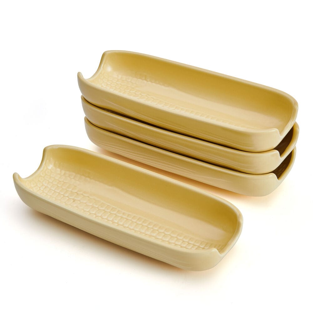 Set of four stoneware corn dishes arranged on a dining table