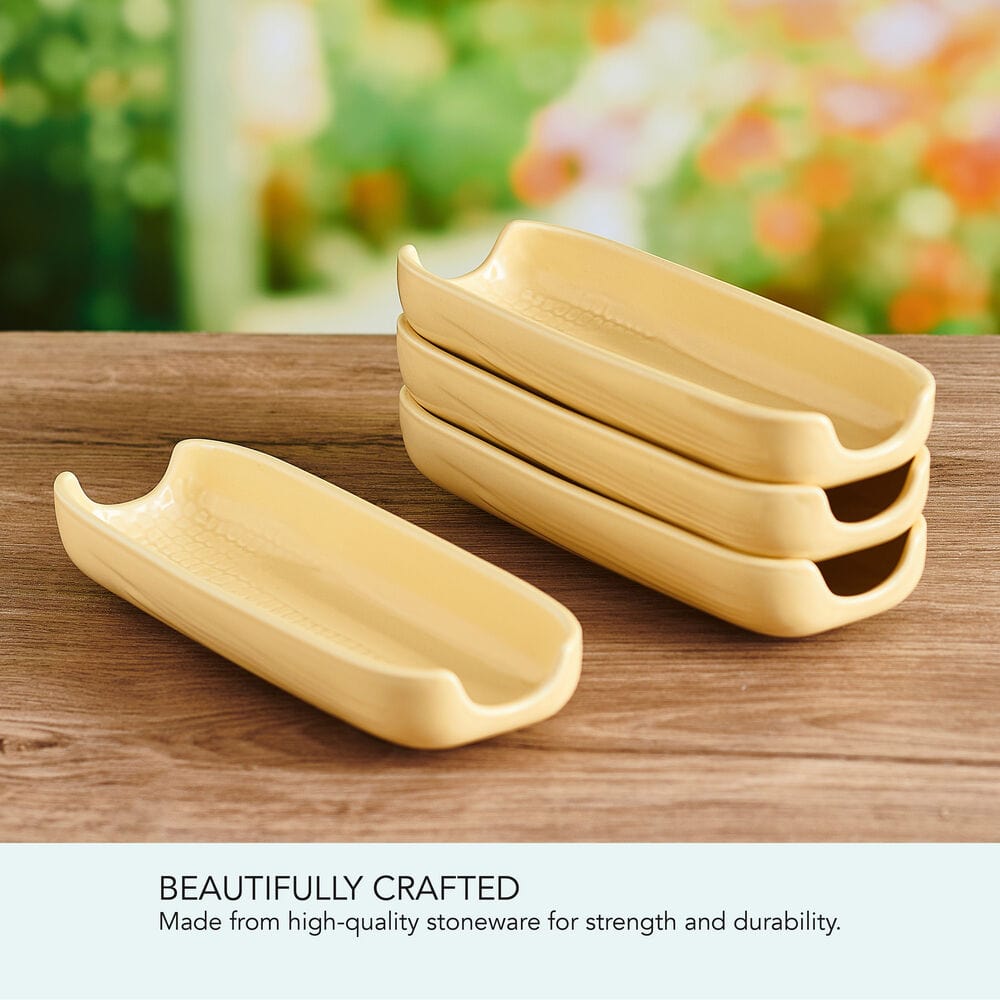 Set of four stoneware corn dishes arranged on a dining table