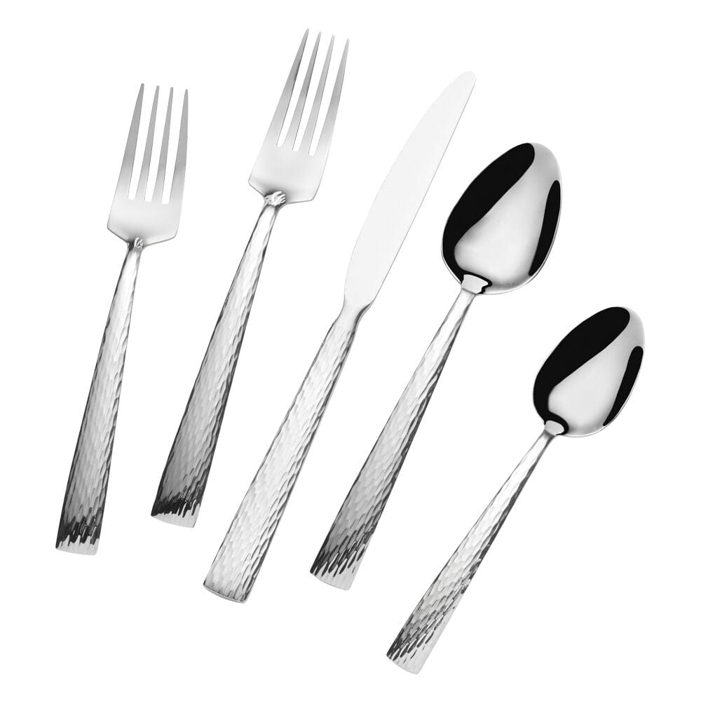 Set of four dinner forks and knives arranged on a contemporary dining table