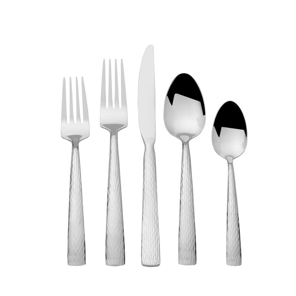 Set of four dinner forks and knives arranged on a contemporary dining table