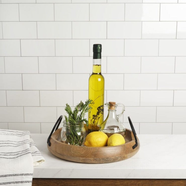 Large mango wood serving tray with iron handles, ideal for hosting gatherings.
