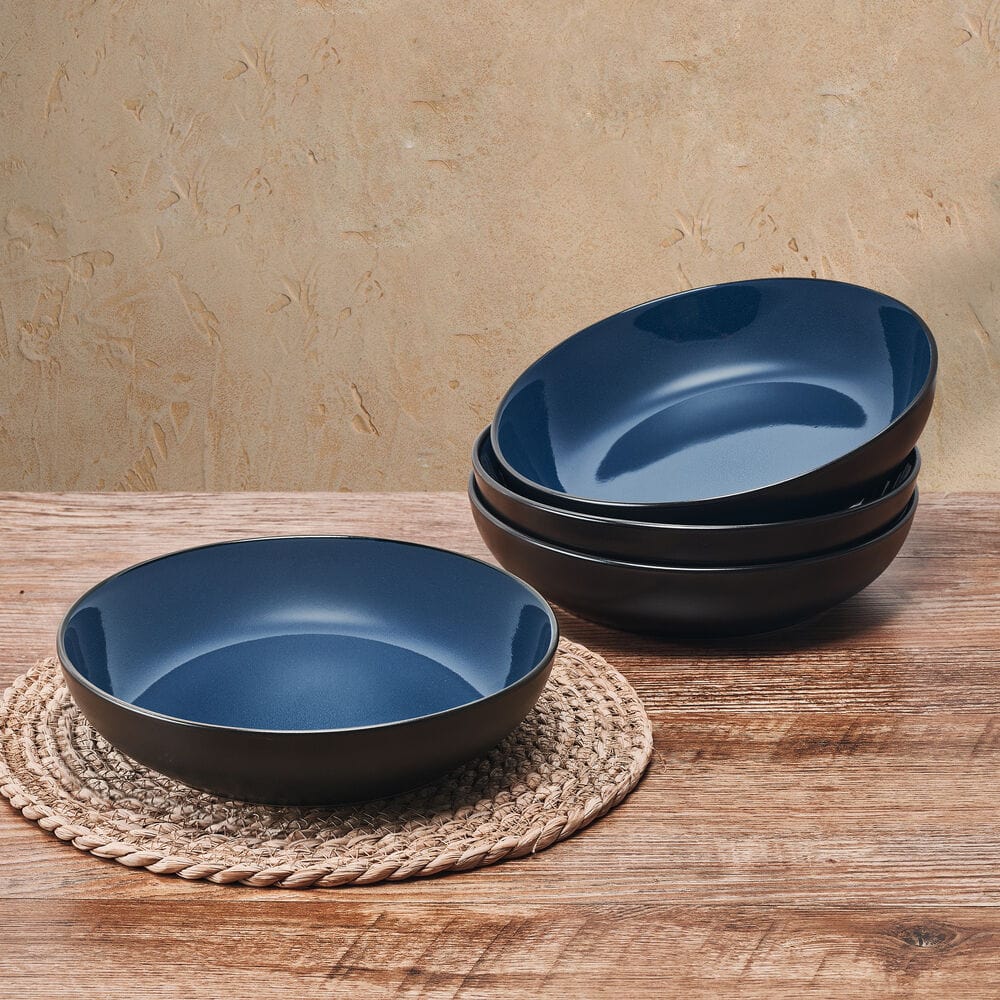 Vibrant blue stoneware pasta bowl set from above, showcasing unique coupe shape.
