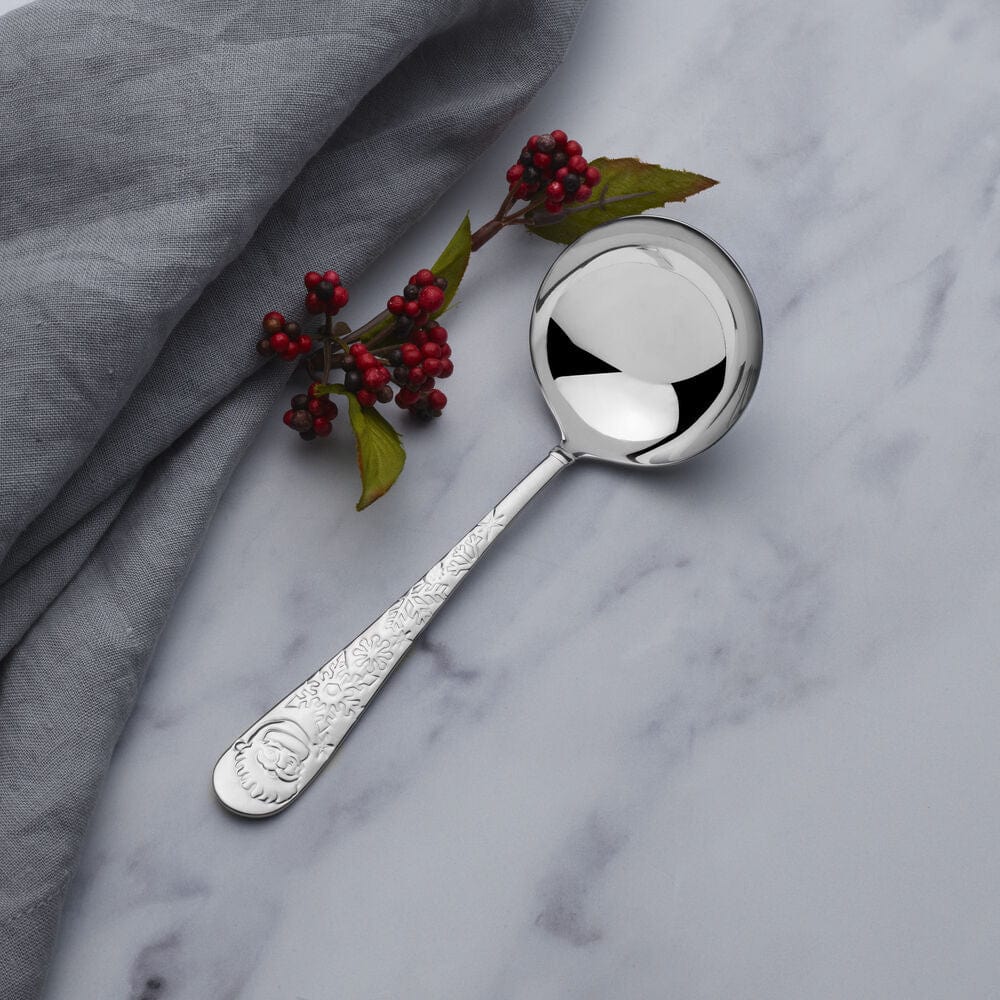 Close-up of stainless steel ladle with Santa face and snowflake detail on handle