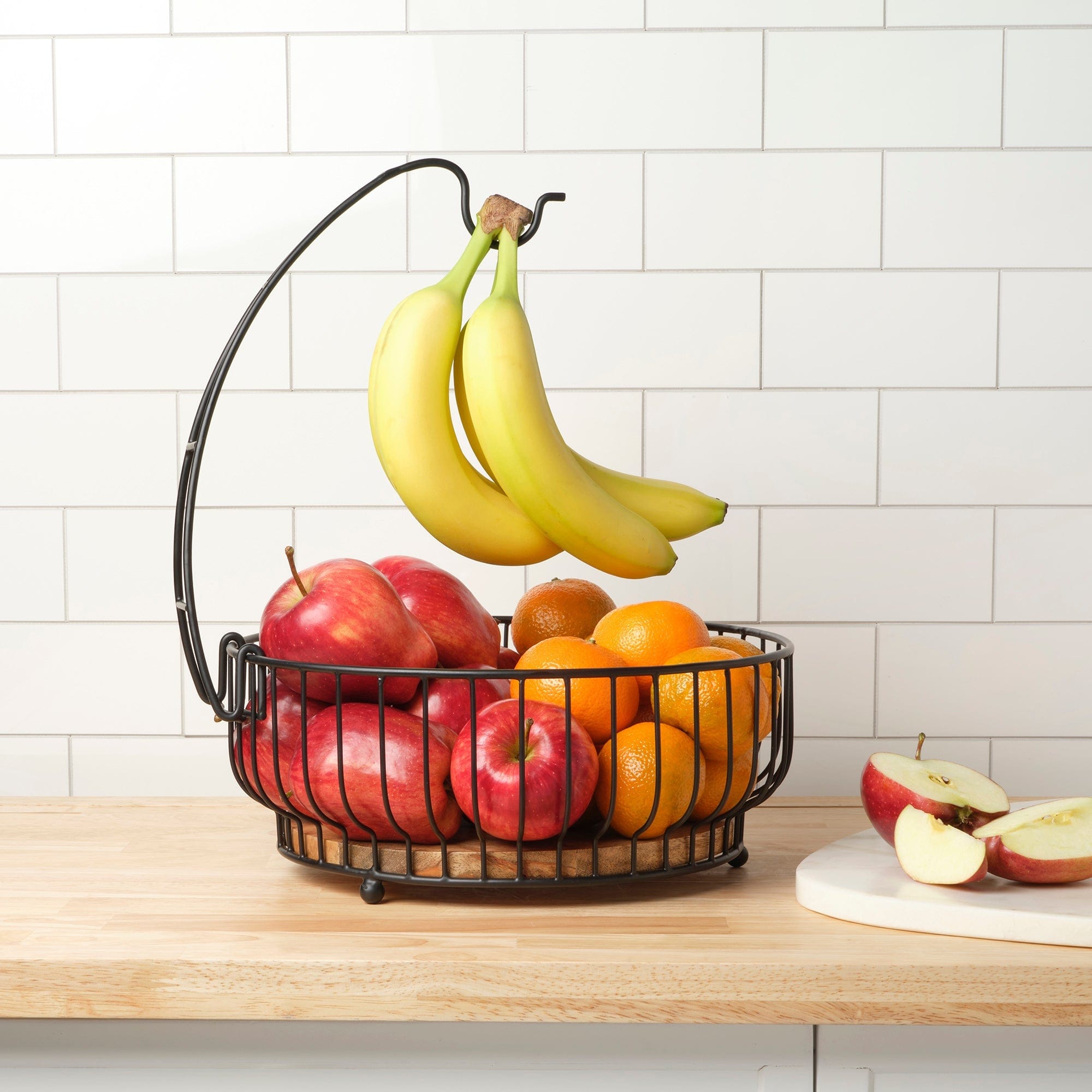 Close-up of Savannah fruit basket with banana hook and mango wood base in a modern kitchen