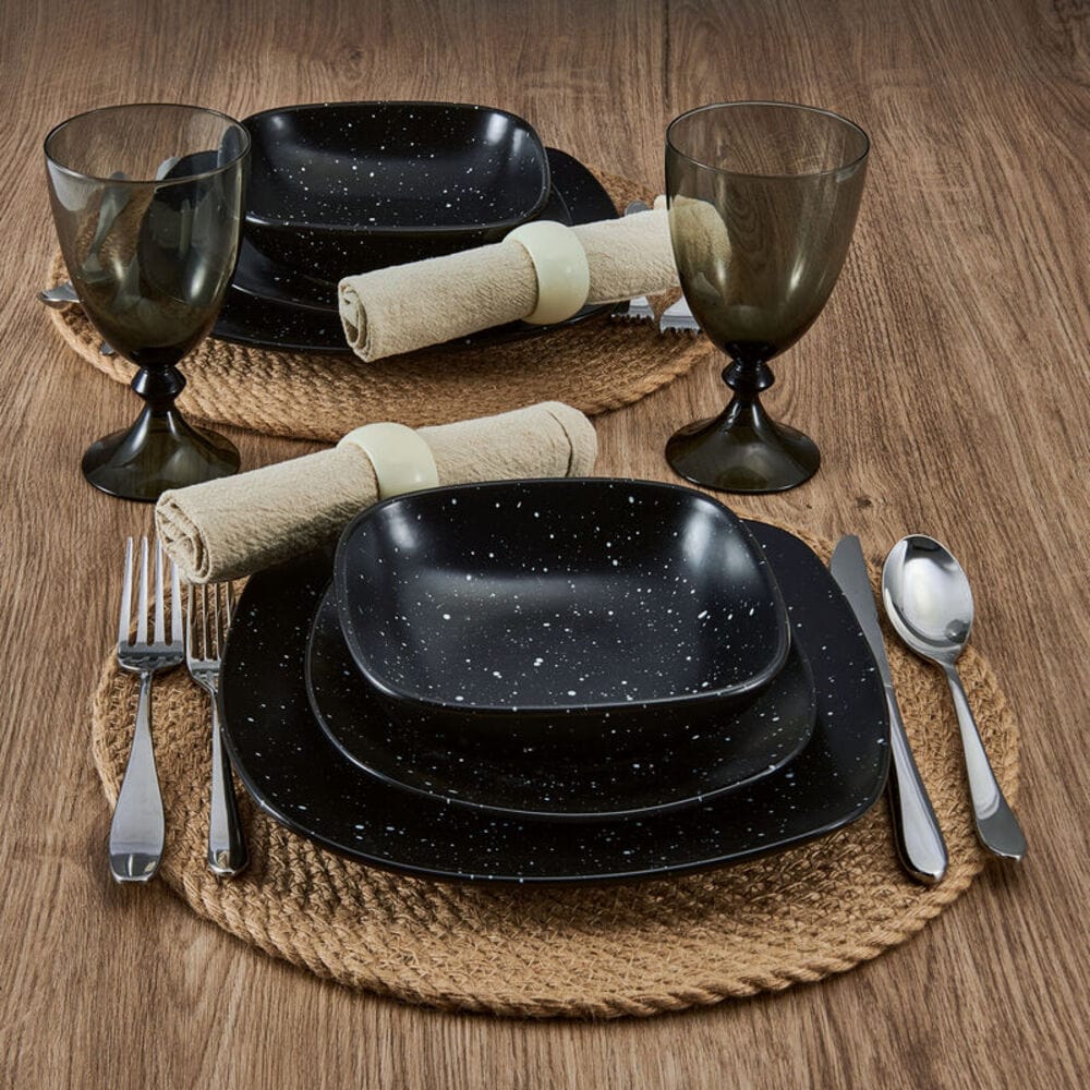 Stacked stoneware bowls and plates with galaxy design on a contemporary table