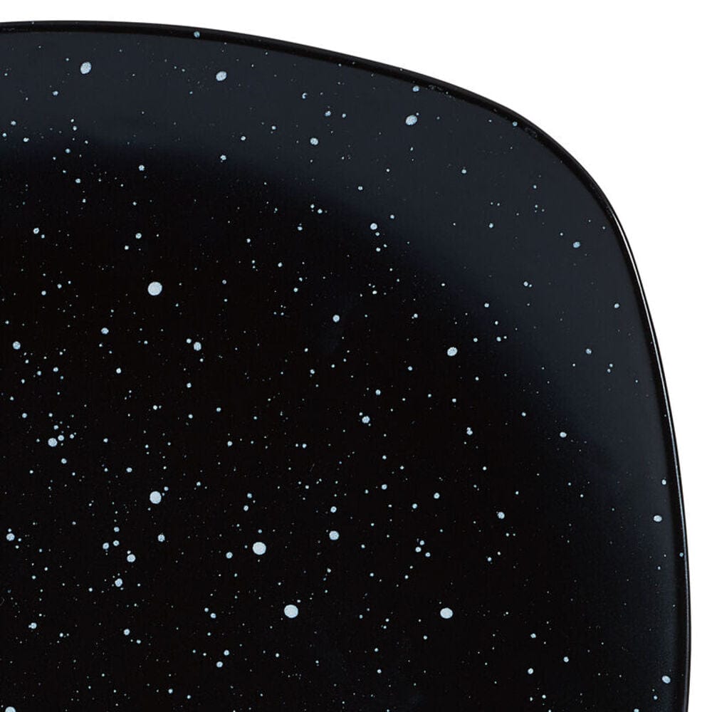 Stacked stoneware bowls and plates with galaxy design on a contemporary table