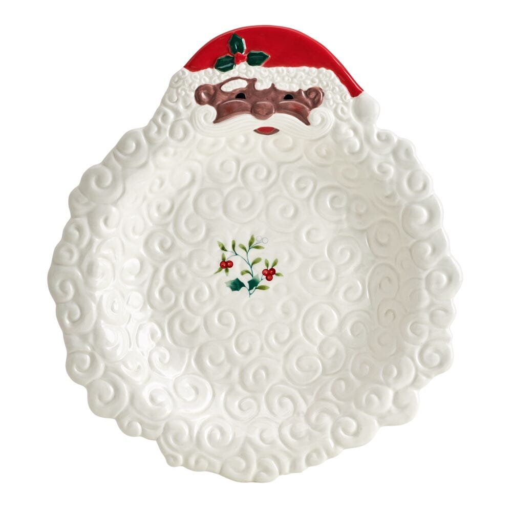 Festive holiday table featuring Santa serveware with winterberry accents
