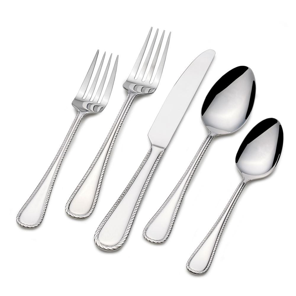 Set of flatware for 8 people arranged on a dinner table, ready for a dinner party