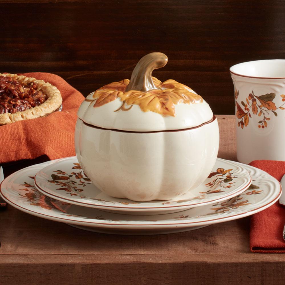 Handcrafted pumpkin bowl with lid showcasing autumn decor accents.