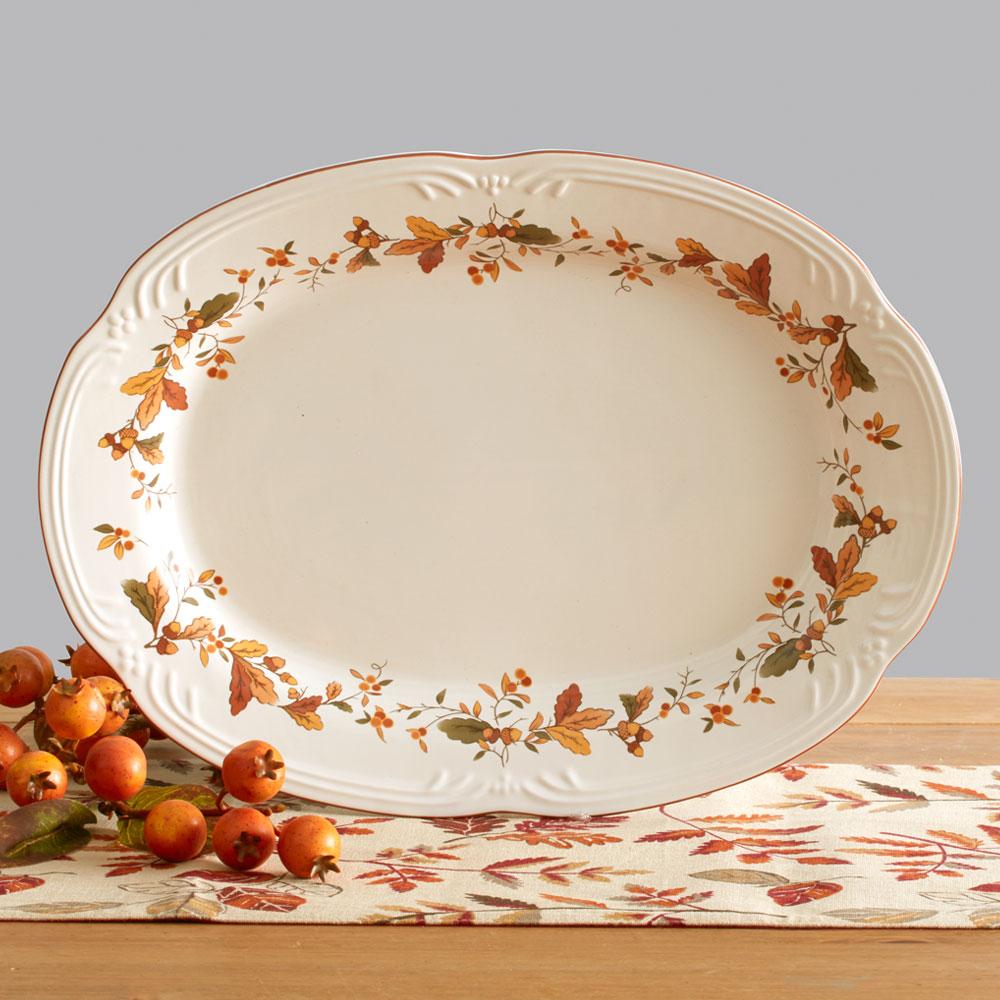 Rustic stoneware oval platter with autumn berry design, perfect for dinner parties.