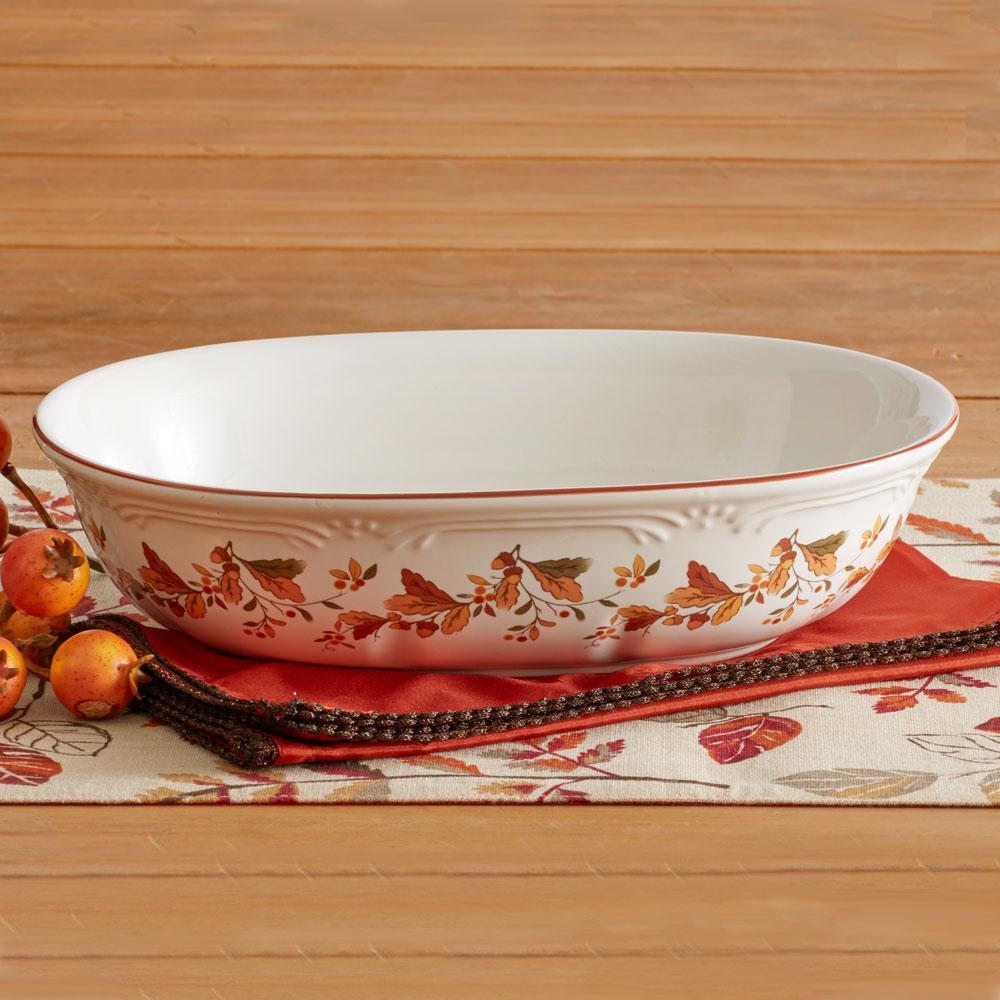 Close-up of autumn berry design on oval stoneware bowl for serving vegetables