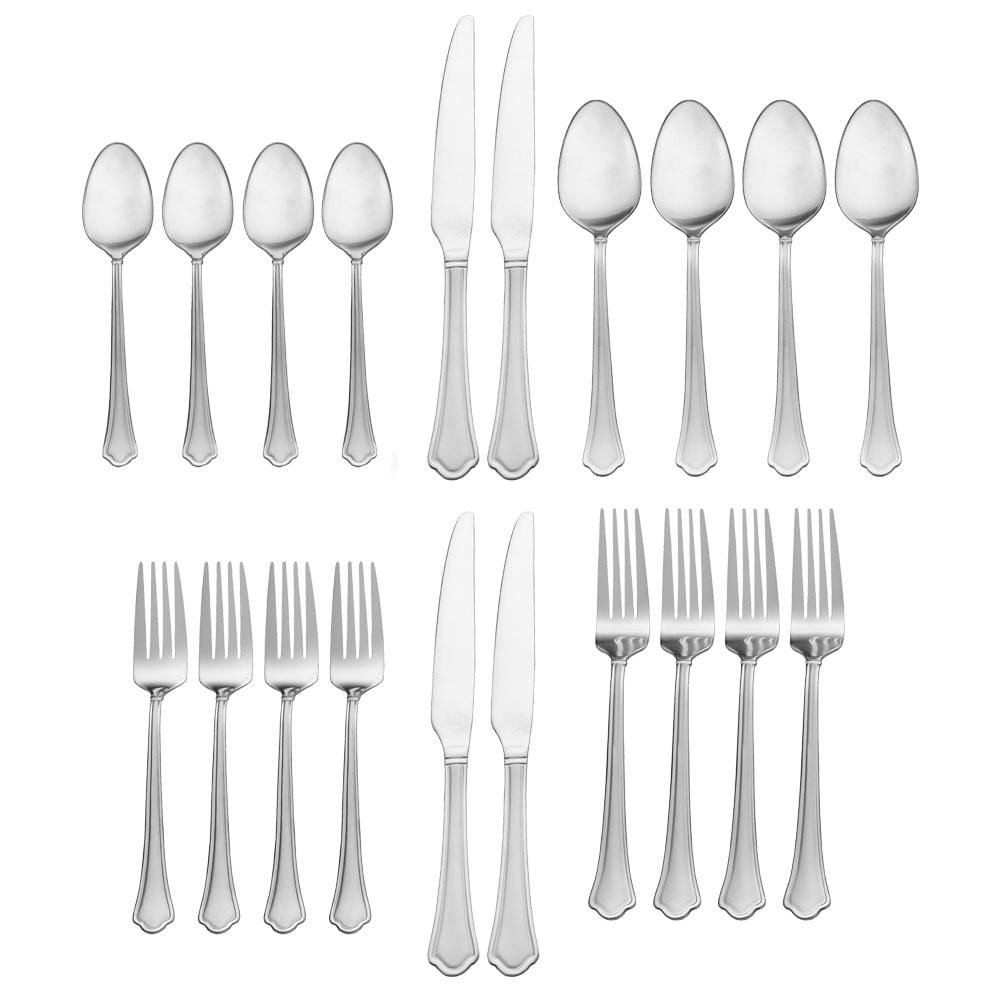 Dinner table setup with stainless steel flatware for four people