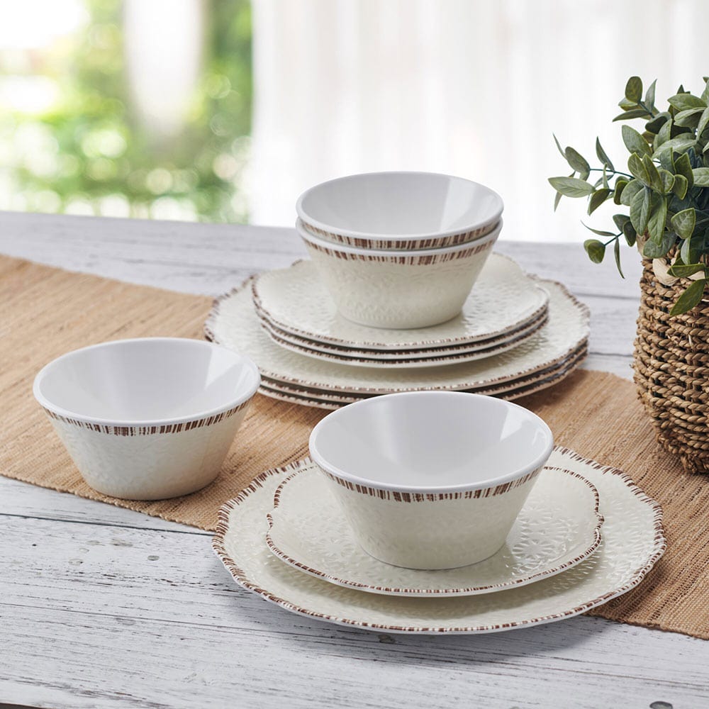 Chateau Cream dinnerware set stacked with outdoor scenery in the background