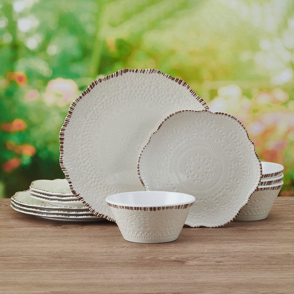 Chateau Cream melamine dinnerware set displayed on a picnic table with food
