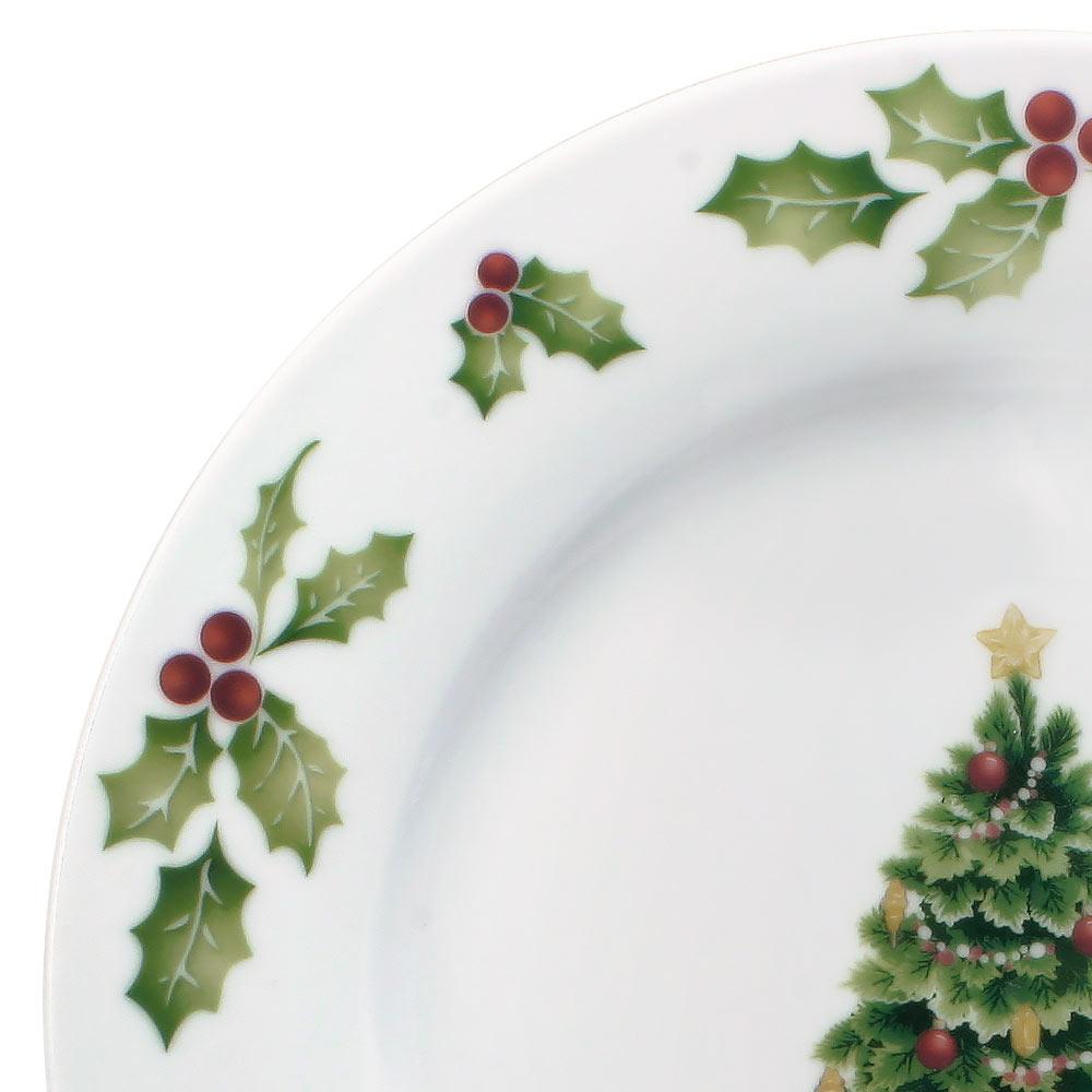 Family gathering with Christmas dinnerware set on a decorated holiday table