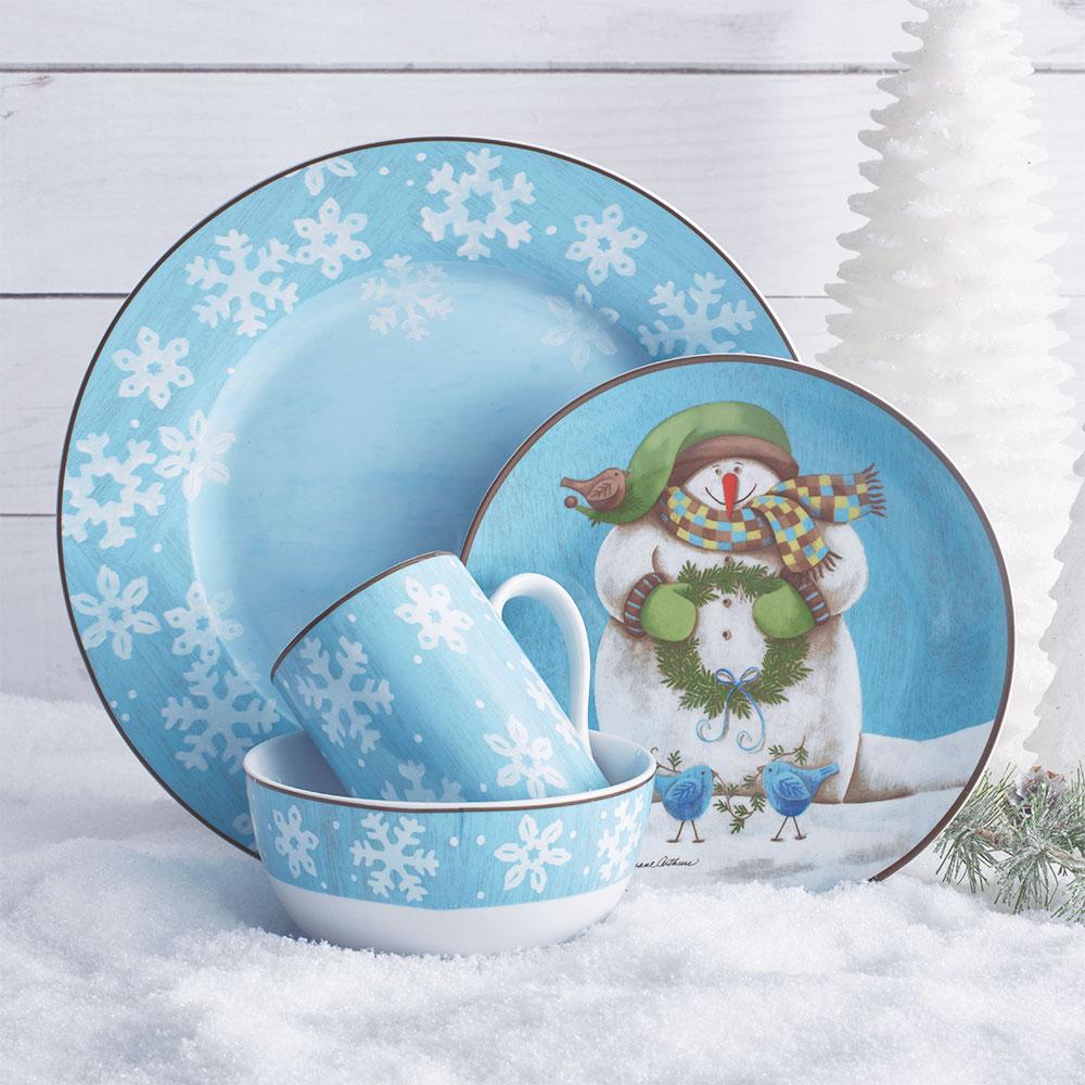 Top view of Snowman Delight dinnerware set showcasing four unique plates and bowls.