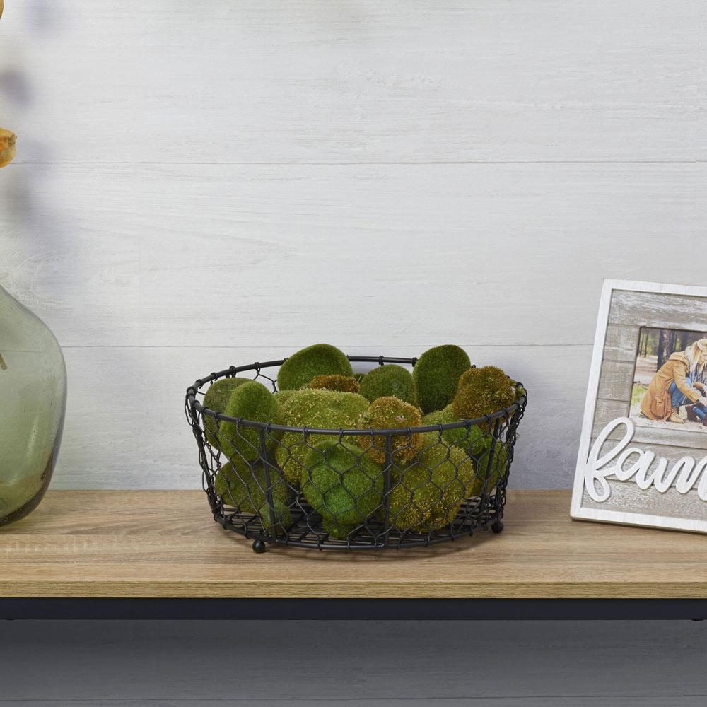 The large black centerpiece fruit basket in a kitchen setting, showcasing its versatility.