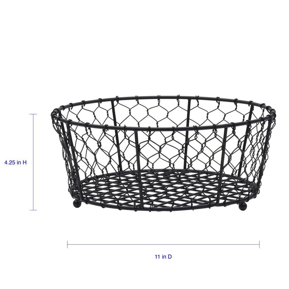 Elegant black wire fruit basket displayed on a dining table filled with colorful fruits.